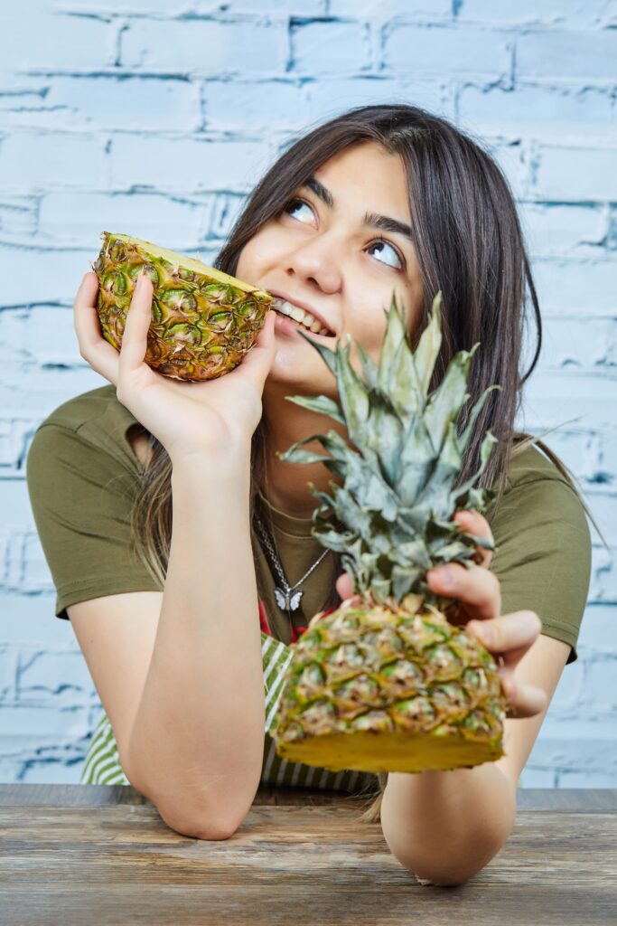 girl thinking about weight loss with pineapple